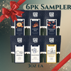 6PK Sampler of Utica Coffee with various flavors and a red bow on a decorative background